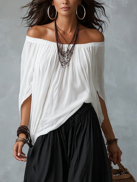 Conjunto de top blanco con hombros al aire y pantalones acampanados estilo linterna