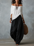 Conjunto de top blanco con hombros al aire y pantalones acampanados estilo linterna